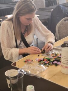 A woman diligently working on a Lego project at a table