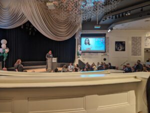 A man delivers a speech to an engaged crowd, showcasing his confidence and connection with the audience.