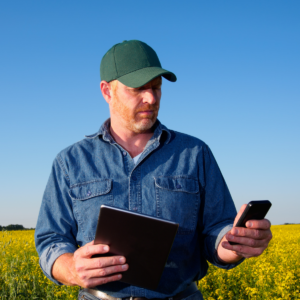 man working outside with cell phone in hand