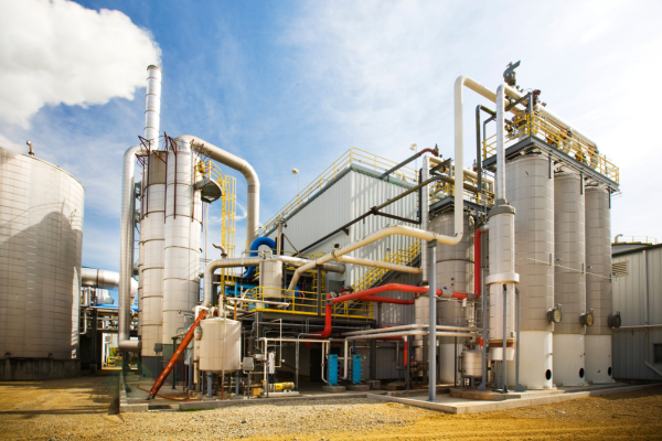 A large industrial plant featuring extensive networks of pipes and machinery, showcasing its complex infrastructure.