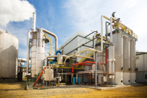 A large industrial plant featuring extensive networks of pipes and machinery, showcasing its complex infrastructure.