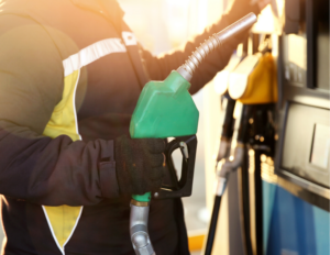 Photo of man holing green fuel pump dispenser