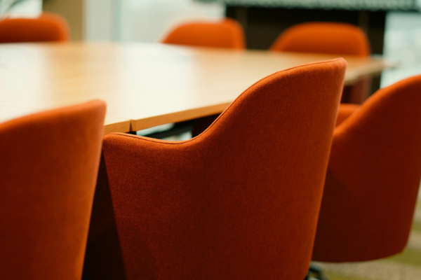 Photo of a board room with orange color chairs